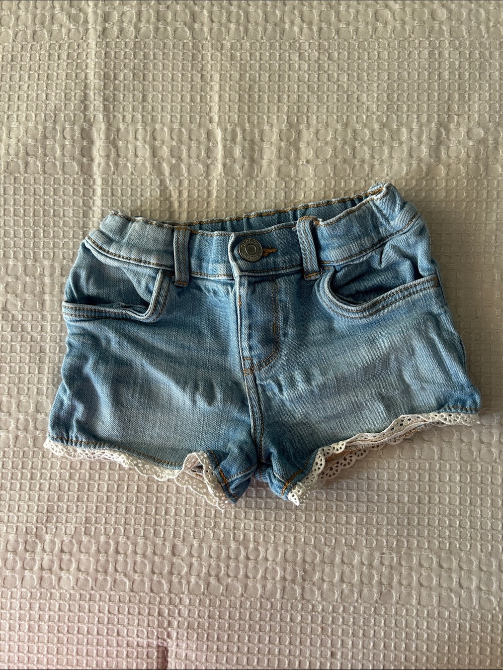 OshKosh B'gosh light-wash toddler denim shorts with white lace trim